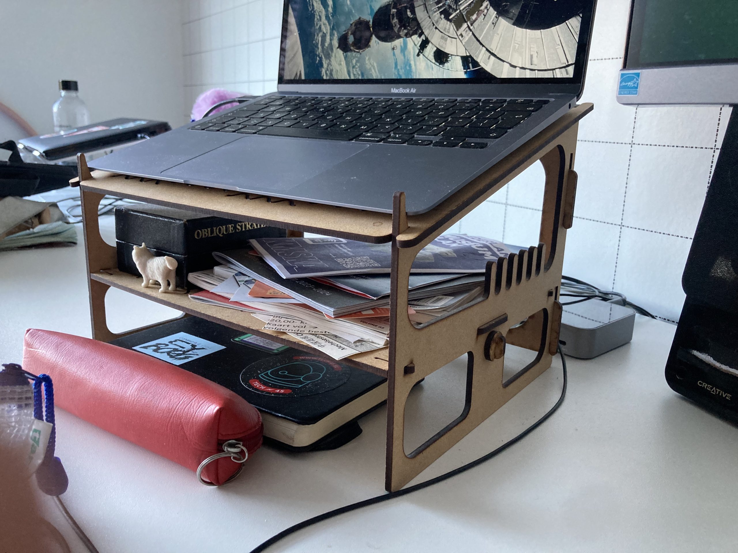 Foto van een laptop op een MDF laptopstand. De laptopstand heeft twee niveaus.